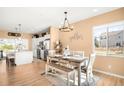 Inviting dining area with a modern chandelier, a stylish table setting, and lots of natural light at 11052 Sedalia St, Commerce City, CO 80022