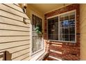 Charming entryway featuring a decorative security door, brick accents and a window for natural light at 13792 E Lehigh Ave # E, Aurora, CO 80014