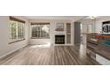 Sunlit living area featuring a cozy fireplace, large windows, and stylish bar for entertaining guests at 13792 E Lehigh Ave # E, Aurora, CO 80014
