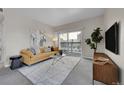 Bright living room featuring a large window, stylish furniture, and modern decor at 1050 Opal St # 102, Broomfield, CO 80020