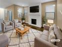 Virtually staged living room with fireplace and comfy seating at 4723 Joplin St, Denver, CO 80239