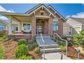 Inviting entryway featuring stone accents, a modern glass door, and well-manicured landscaping leading to the home at 8392 Niwot Meadow Farm Rd, Niwot, CO 80503