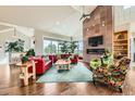 Bright living room with high ceilings, stone fireplace, large windows, and comfortable seating, creating an open and airy feel at 8392 Niwot Meadow Farm Rd, Niwot, CO 80503