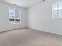 Bright, sunlit bedroom with neutral carpet and paint and a large window overlooking a snow-covered landscape at 9153 Truckee Ct, Commerce City, CO 80022
