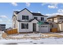 Charming two-story home with a modern farmhouse design, featuring a two-car garage and landscaped front yard at 9153 Truckee Ct, Commerce City, CO 80022