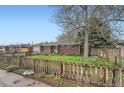A charming brick home with well-kept lawn and a picket fence that adds to the property's appeal at 1740 S Estes St, Lakewood, CO 80232