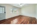 Bright living room featuring beautiful hardwood floors, a ceiling fan, and a large window for natural light at 1740 S Estes St, Lakewood, CO 80232