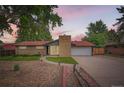 Charming single-story home with brick facade, manicured lawn, and a welcoming entrance at 7491 W 45Th Ave, Wheat Ridge, CO 80033