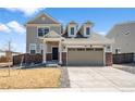 Daytime shot of a charming two-story home with a two-car garage and manicured front yard at 13516 Waterthrush St, Parker, CO 80134