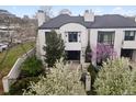 Charming home with mature landscaping and architectural details at 325 Clayton St, Denver, CO 80206
