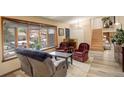 Bright living room with a large window, comfortable seating and staircase at 13695 W 67Th Cir, Arvada, CO 80004
