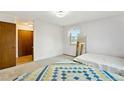 Bright bedroom with neutral carpet, ample natural light, and a closet for storage at 2410 S Lima St, Aurora, CO 80014