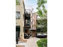 Close-up of apartment entrance with brick facade, wrought-iron balconies, and secure mailboxes at 636 N Washington St # 301, Denver, CO 80203