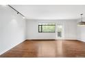 Bright living room featuring hardwood floors, a large window, and a door to the outside at 636 N Washington St # 301, Denver, CO 80203