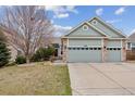 Charming home with a three-car garage, manicured lawn, and beautiful curb appeal on a sunny day at 14938 Clayton St, Thornton, CO 80602