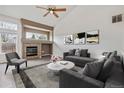 Cozy living room with a fireplace, plush seating, and stylish decor for relaxation and entertainment at 14938 Clayton St, Thornton, CO 80602