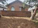 Brick house with a small front yard and mature trees at 1257 Quitman St, Denver, CO 80204