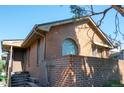Brick home showcasing arched window and covered entrance at 1257 Quitman St, Denver, CO 80204
