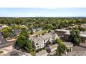 Aerial view of the condo complex near a lake and park with a skyline view in the distance at 5745 W Atlantic Pl # 108, Lakewood, CO 80227