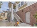 Exterior view of townhome, showcasing the brick facade, staircase, and convenient side entrance at 3010 W Prentice Ave # J, Littleton, CO 80123