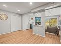 Bright living room with wood-look floors, closet, and a peek through to the living area with sliding glass doors at 12112 Melody Dr # 302, Denver, CO 80234