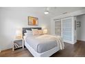 This cozy bedroom features hardwood floors, ceiling fan, warm lighting, and sliding closet doors at 1032 N Clarkson St # 201, Denver, CO 80218