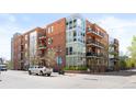 Beautiful brick building featuring multi-level balconies and large modern windows at 1401 Delgany St # 211, Denver, CO 80202