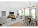 Bright living room with large windows, hardwood floors, and modern furnishings at 1401 Delgany St # 211, Denver, CO 80202