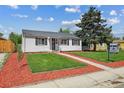Inviting home featuring a lush green lawn, a walkway, and a well-maintained exterior at 925 Fulton St, Aurora, CO 80010