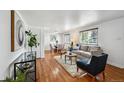 Bright and airy living room featuring hardwood floors, dining area, and neutral decor at 925 Fulton St, Aurora, CO 80010