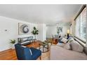 Cozy living room featuring hardwood floors, modern furniture, and abundant natural light at 925 Fulton St, Aurora, CO 80010
