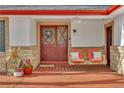 Close-up of front porch showing the swing, entry door, and decorative plants at 12079 E Louisiana Ave, Aurora, CO 80012