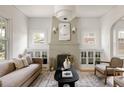 Cozy living room features a decorative fireplace, plush seating, and built-in cabinetry at 4261 Julian St, Denver, CO 80211