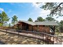 Charming single-story home featuring stone accents and a covered porch for enjoying the outdoors at 25392 Westridge Rd, Golden, CO 80403