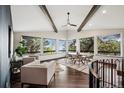 Bright living room with wood floors, large windows showcasing trees, and comfortable seating at 25392 Westridge Rd, Golden, CO 80403