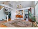 Grand entryway with hardwood floors, statement mirror, chandelier, and high ceilings offers a bright welcoming space at 6590 S Tabor St, Littleton, CO 80127