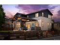 Gorgeous covered outdoor living space with a patio, fire pit, and fenced yard at 14110 Pastel Ln, Parker, CO 80134