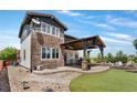 Stunning backyard with a stone patio, a covered pergola, and lush landscaping at 14110 Pastel Ln, Parker, CO 80134