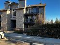 Charming condo building with stone facade, balconies, and mature landscaping offers a inviting curb appeal at 2575 S Syracuse Way # M108, Denver, CO 80231