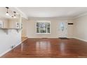 Spacious living room with gleaming hardwood floors, bay window, and great natural light at 640 S Quivas St, Denver, CO 80223
