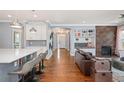 Open-concept living area showcasing a fireplace, built-in shelving, and seamless flow into kitchen at 2746 Geneva St, Denver, CO 80238