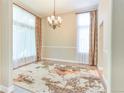 Elegant dining room with natural light, modern chandelier, large windows, and decorative rug at 19249 E Progress Ave, Centennial, CO 80015