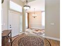 Inviting foyer with hardwood floors, chandelier, and views of the dining room at 19249 E Progress Ave, Centennial, CO 80015