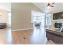 Open living space with hardwood floors, a fireplace, and seamless flow to the dining area at 19249 E Progress Ave, Centennial, CO 80015
