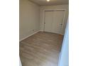 A cozy bedroom with wood-look flooring and a sliding door closet at 1845 N Kendall St # 316D, Lakewood, CO 80214
