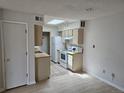 Compact kitchen features white appliances, tile floors and a sun-filled sky light at 1845 N Kendall St # 316D, Lakewood, CO 80214