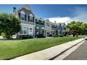 Charming street view showcasing townhomes with lush green lawns and inviting curb appeal at 19804 Summerset Ln, Parker, CO 80138
