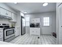 Bright kitchen featuring white cabinets, stainless steel appliances, and neutral flooring at 19804 Summerset Ln, Parker, CO 80138