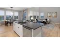 Modern kitchen with island, stainless steel appliances, and hardwood floors at 23890 E Minnow Dr, Aurora, CO 80016