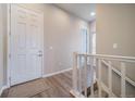 Inviting entryway featuring wood floors, white trim, and staircase leading to the upper level at 195 Silver Rock Trl, Castle Rock, CO 80104